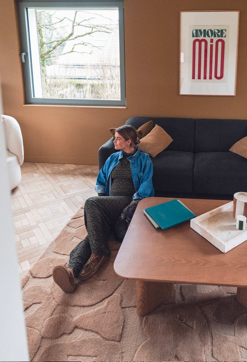 Gabrielle Paris Thelma Coffee Table in natural oak with organic sculptural base in terracotta living room with dark sofa and beige textured rug