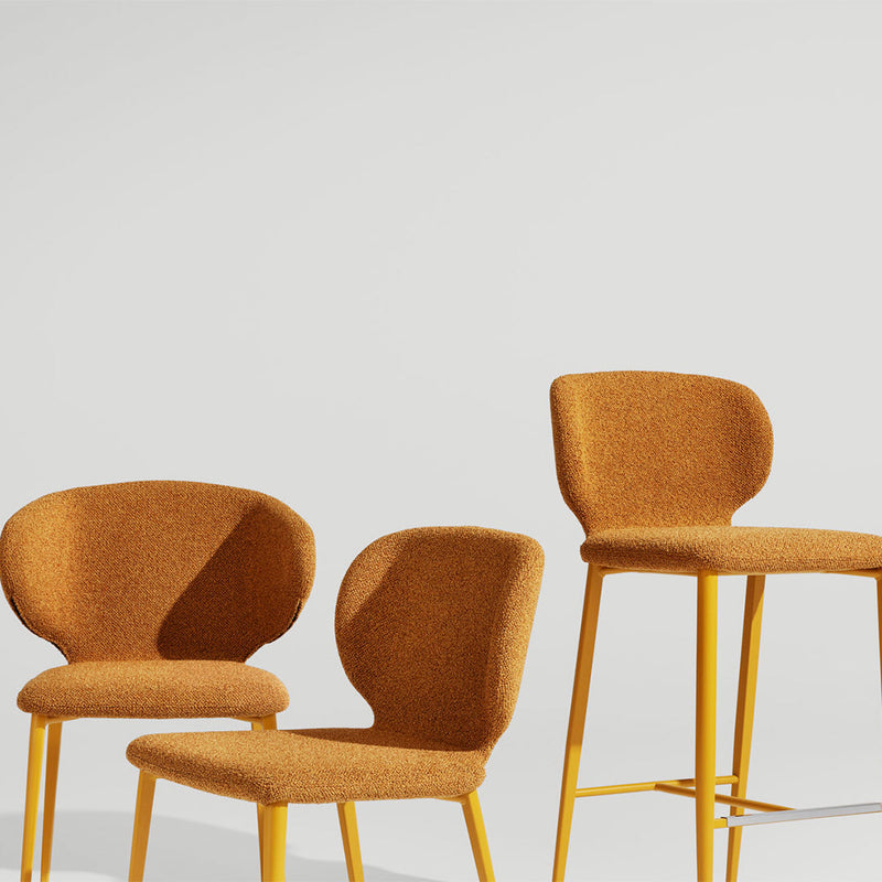 Set of three chairs featuring vibrant mustard yellow fabric and sleek yellow metal legs, creating a modern aesthetic.