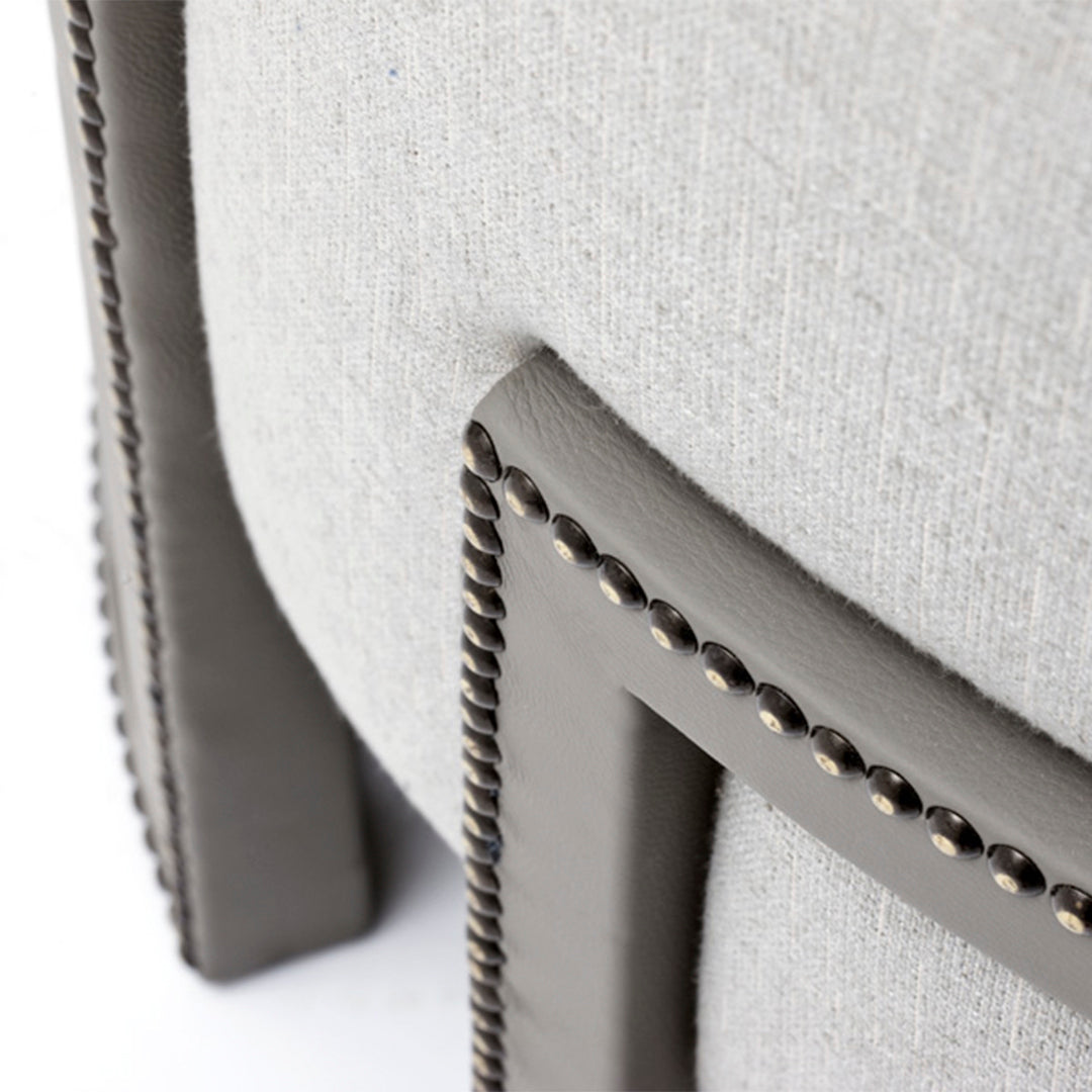 Light gray fabric chair with dark gray accents and braided trim detail.