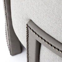 Light gray fabric chair with dark gray accents and braided trim detail.