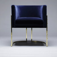 Navy blue velvet chair with sleek gold metal legs, perfect for modern decor. Elegant and stylish design.