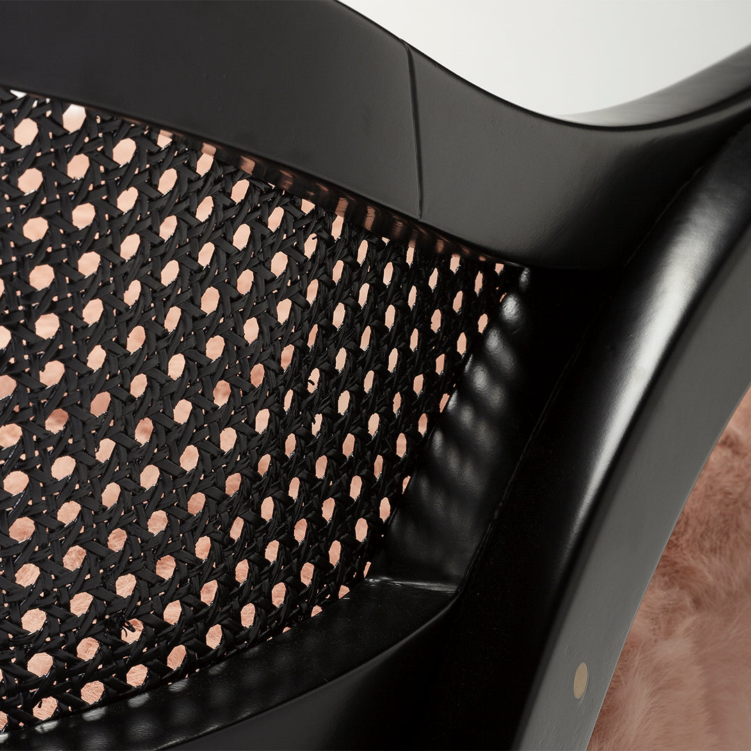 Black mesh pattern with circular cutouts, complemented by soft pink accents on a sleek, modern design.