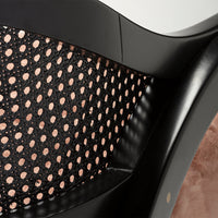 Black mesh pattern with circular cutouts, complemented by soft pink accents on a sleek, modern design.