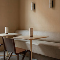 Neutral beige tones with soft textures; minimalist design featuring clean lines and subtle contrast in seating and decor.