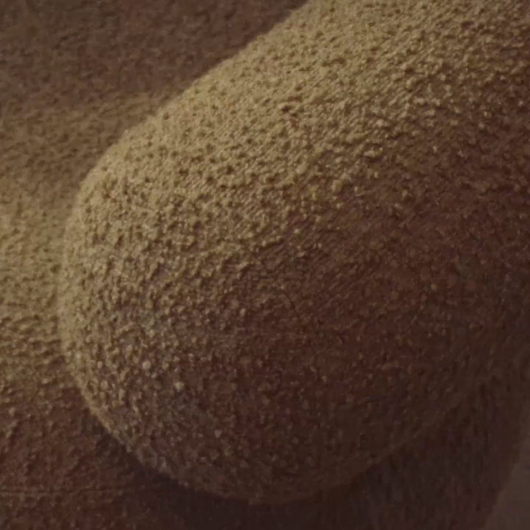 Tan textured fabric with a soft, plush surface and subtle, irregular pattern. Ideal for cozy decor.