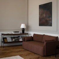 Rustic brown sofa in a modern living room with a neutral palette and sleek black accents. Elegant minimalistic design.
