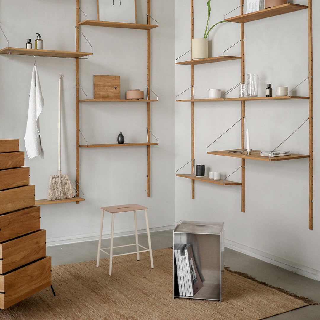 "Minimalist wooden shelves with light brown tones, natural textures, and a patterned woven rug."