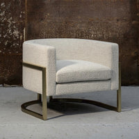 Stylish round chair in soft beige textured fabric with a sleek gold metal base, perfect for modern interiors.