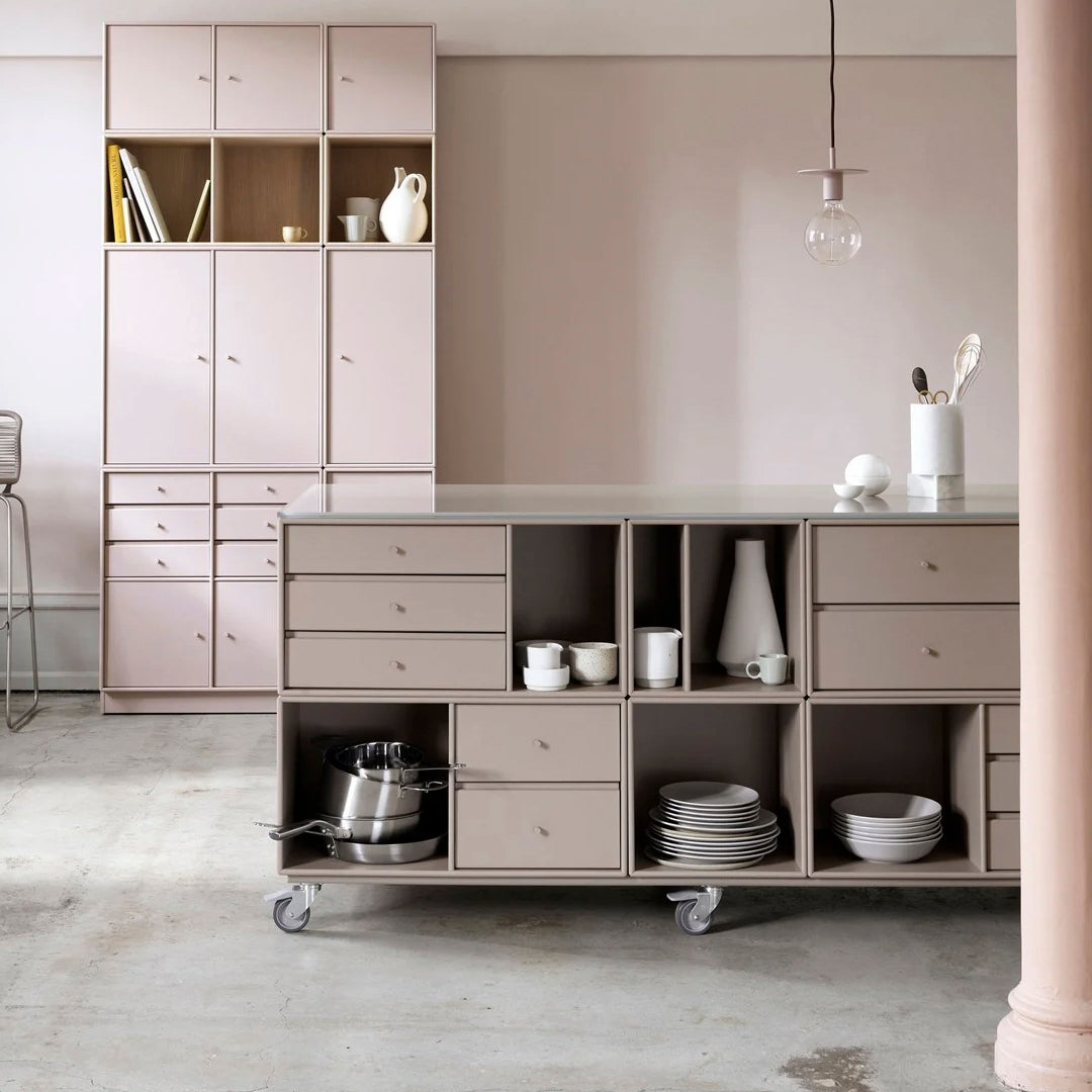 Minimalist kitchen storage in soft pink and beige tones with clean lines and smooth surfaces.