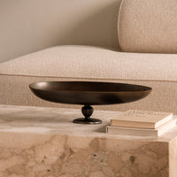 Stylish black metal serving bowl with a smooth finish, set on a marble surface. Elegant and modern decor piece.