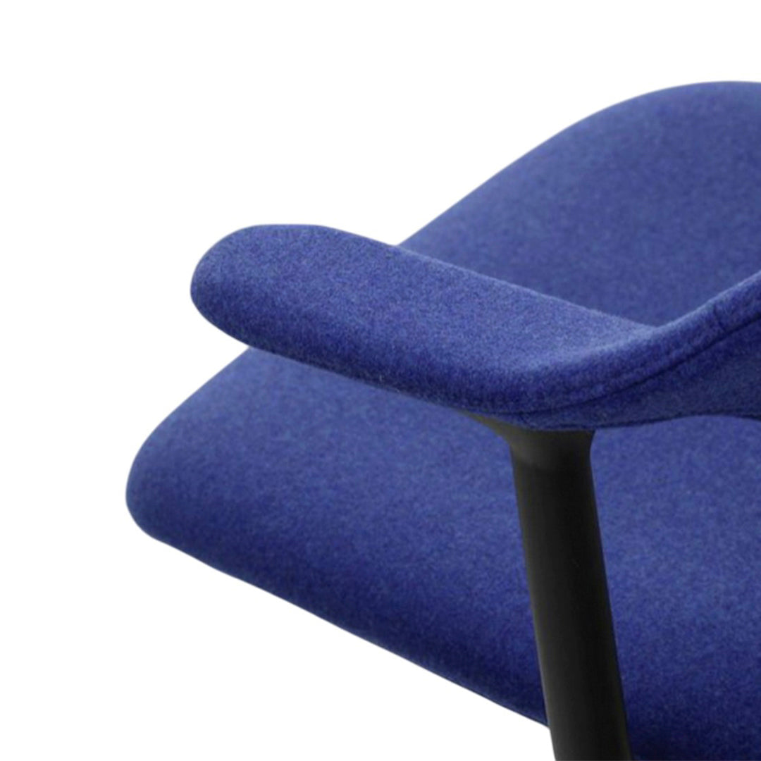Close-up of a soft blue chair fabric with a sleek black armrest, featuring a smooth, solid color and subtle texture.