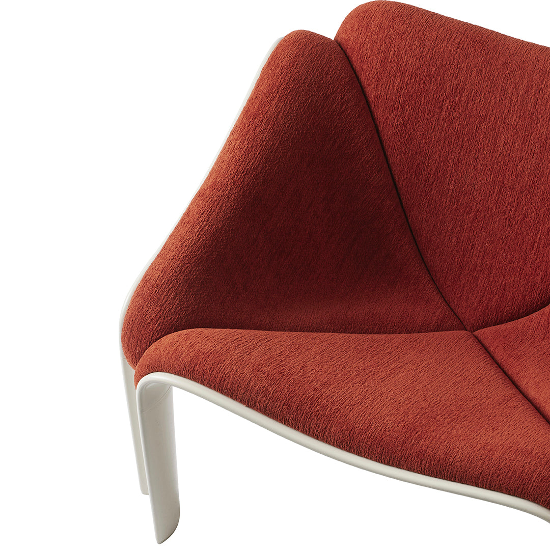 Red textured fabric chair detail with a sleek white base. Modern design showcasing a bold color contrast.