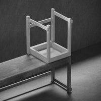 Minimalist black and white wooden chair design, featuring clean lines and a geometric pattern.