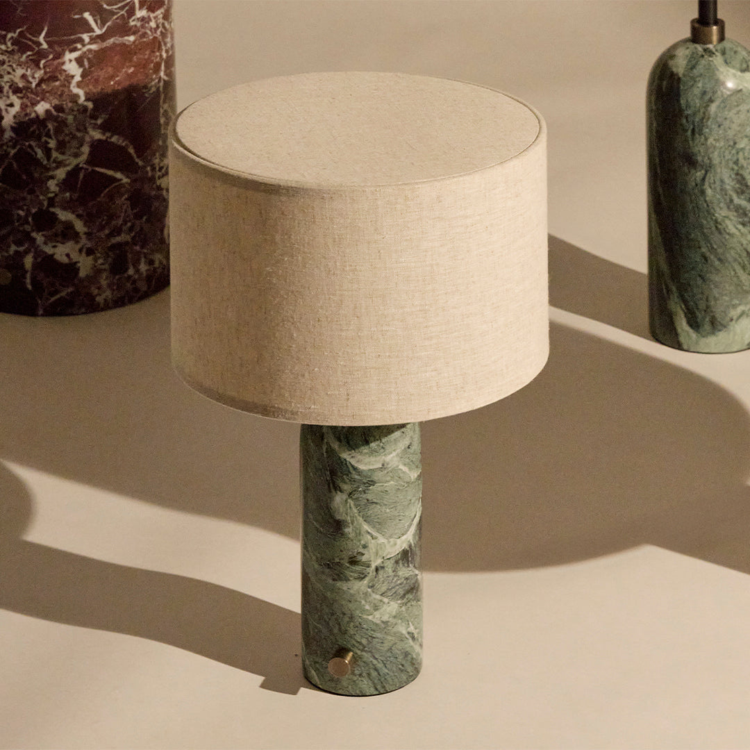 Green marble lamp with a beige fabric shade, featuring subtle veining and a smooth finish. Elegant home decor accent.