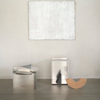 Sleek metallic finishes with geometric patterns, featuring silver, black, and warm beige accents. Modern minimalist decor.