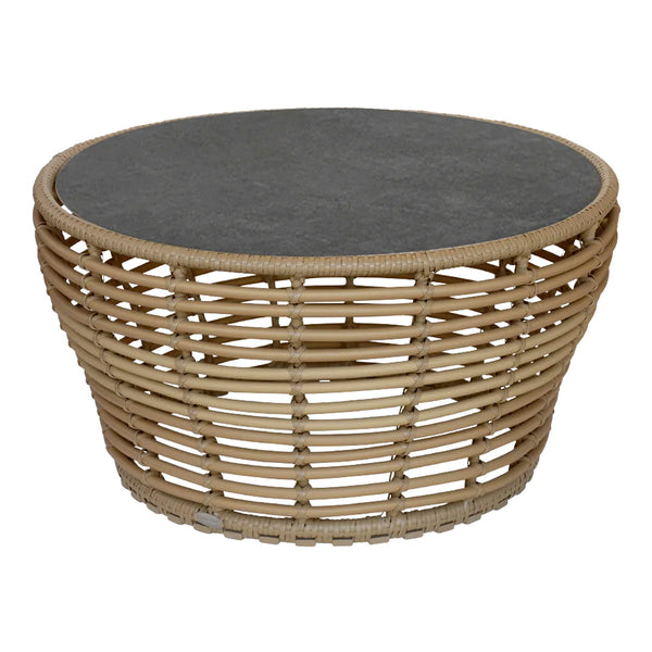 Natural wicker coffee table with a dark gray stone top and a woven, circular design. Ideal for modern decor.