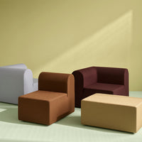 Colorful modern furniture set: light gray, rich brown, deep burgundy, and soft yellow against a pale green background.