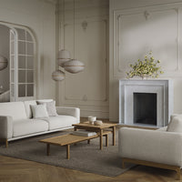 Neutral-toned living room with cream sofas, light wood accents, and subtle textures, topped with minimalist decor.