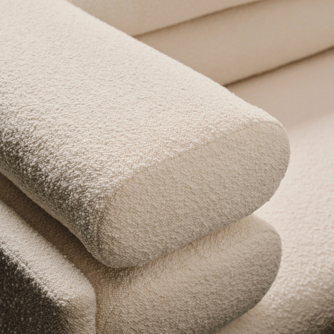 Light beige textured fabric with a soft, cozy appearance, featuring a smooth, rounded edge design.