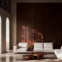 Modern white sofa set with minimalist design, paired with a rich brown wooden coffee table and dark panel backdrop.