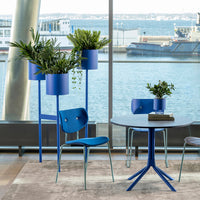 Blue furniture set with matching planters, showcasing vibrant blue hues and modern geometric patterns against a natural backdrop.