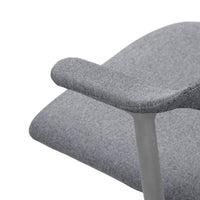 Gray upholstered chair with a subtle herringbone pattern and sleek metal armrests.