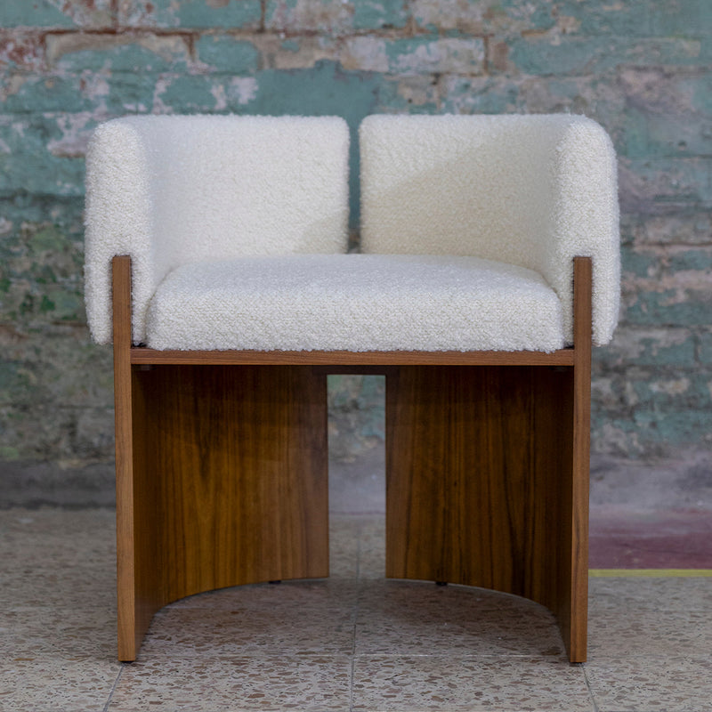 "Textured white fabric seat with wooden base, adding a contemporary touch to any space."