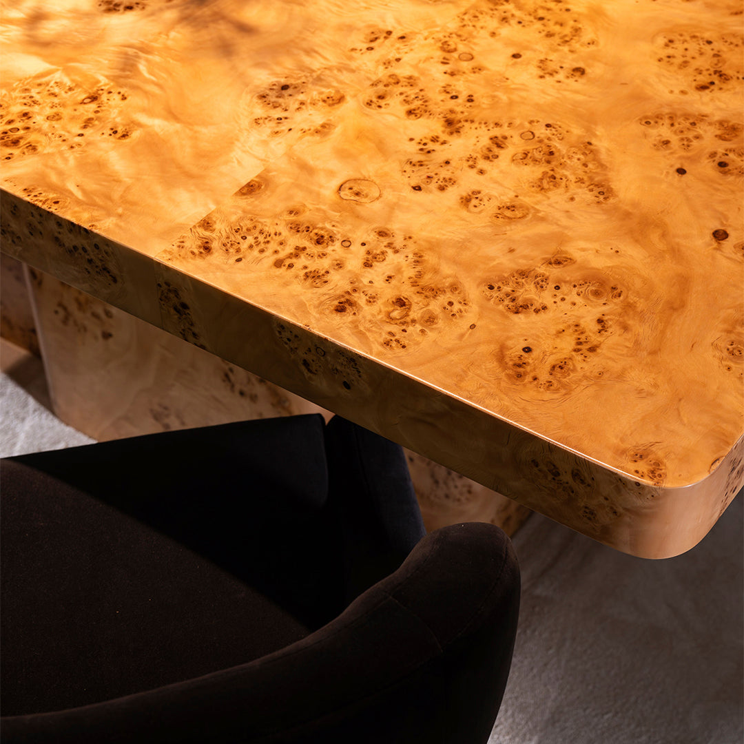 Wooden table surface featuring rich golden hues and intricate burl patterns. Modern elegance for any space.