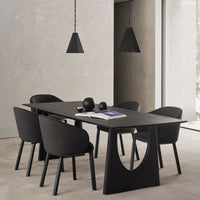 Black dining table with matching chairs, featuring sleek lines and modern geometric patterns. Elegant minimalist design.
