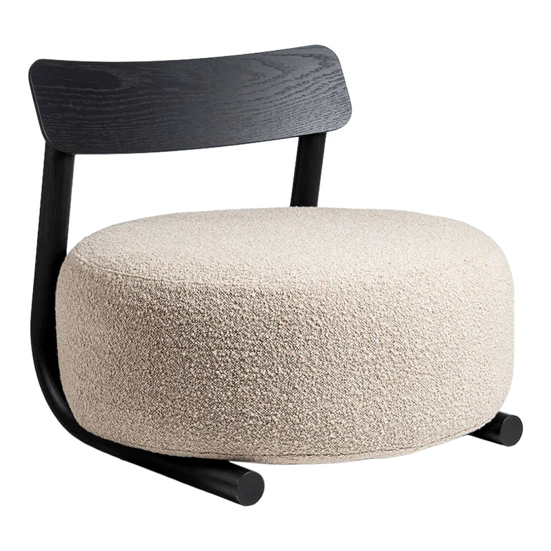 Beige textured cushion chair with a sleek black wooden backrest and curved black legs. Ideal for modern decor.