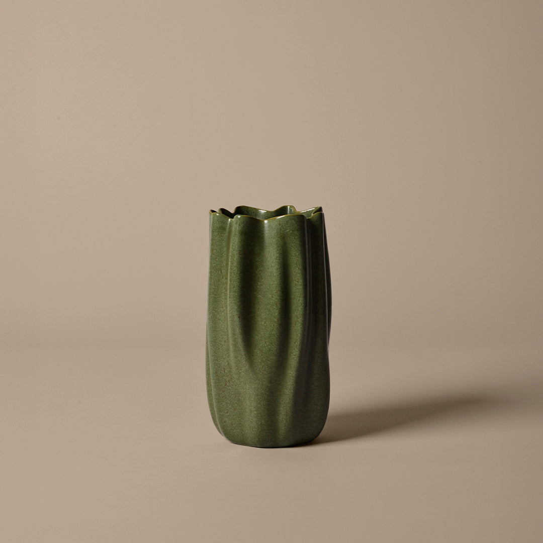 Green textured vase with ribbed design, featuring a fluted top against a neutral background. Ideal for modern decor.