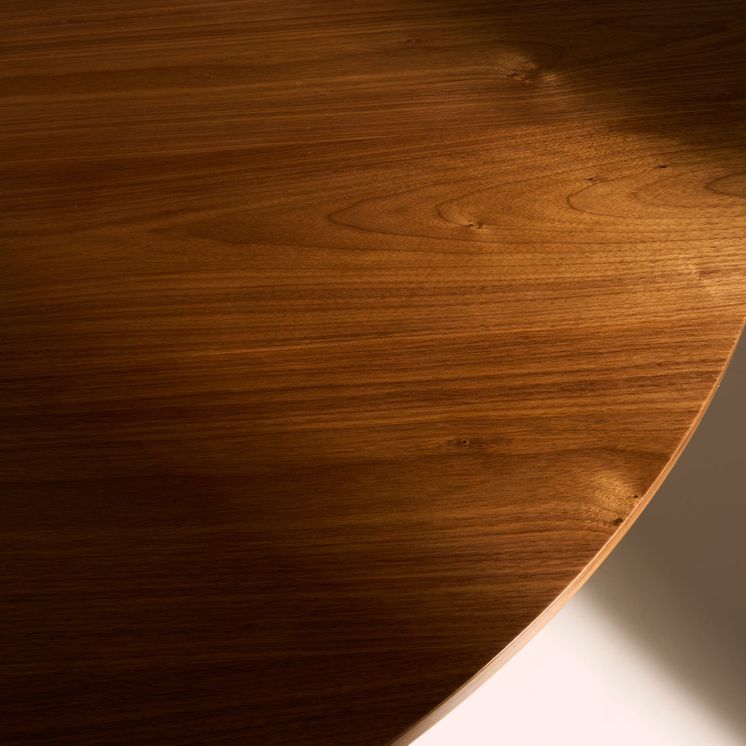 Rich walnut wood surface with smooth, glossy finish and subtle grain patterns. Elegant round shape for modern decor.