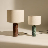Brown and green marble lamps with natural fabric shades, showcasing elegant textures and colors.