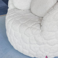 White textured upholstery with quilted pattern, featuring a cozy and plush design. Ideal for modern decor.