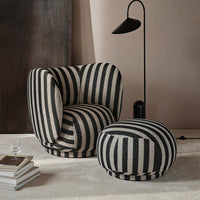 Black and white striped armchair and ottoman in a modern interior setting.