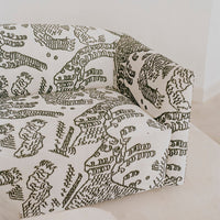 Green and white patterned sofa featuring abstract designs and organic shapes, perfect for modern decor.