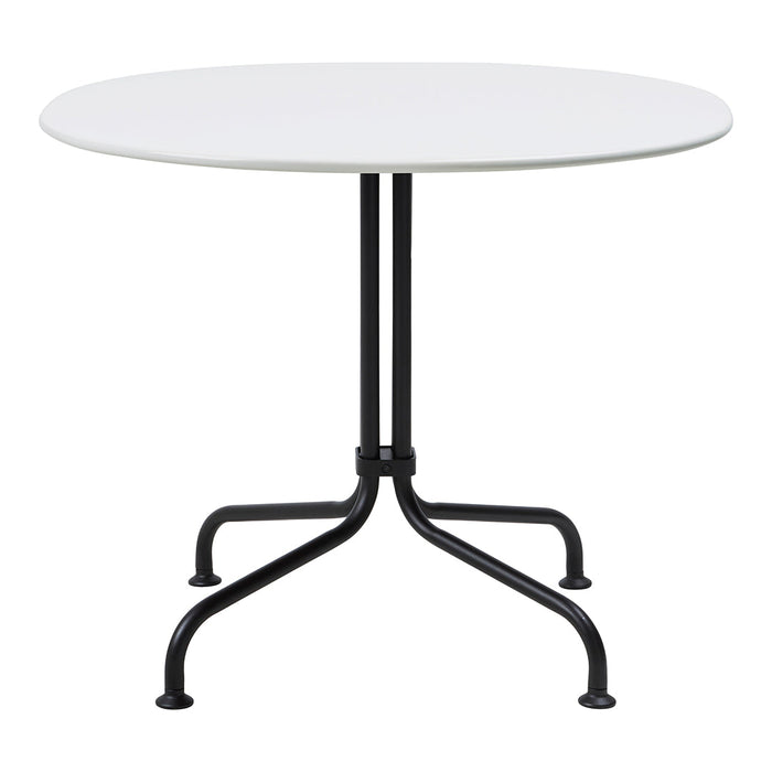 Round table with a sleek white top and contrasting black metal legs, perfect for modern decor.