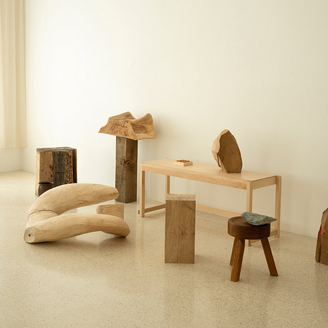 Natural wood furniture showcasing vibrant grains in warm tones with smooth and textured surfaces. Elegant minimalist design.