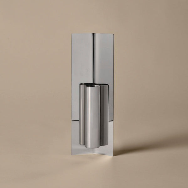 Sleek silver metal with a polished finish, set against a soft beige background. Modern, minimalist design.