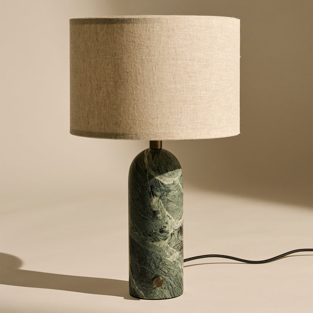 Green marbled lamp base with a beige linen shade, combining natural textures for a modern look.