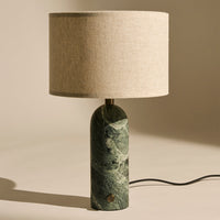 Green marbled lamp base with a beige linen shade, combining natural textures for a modern look.