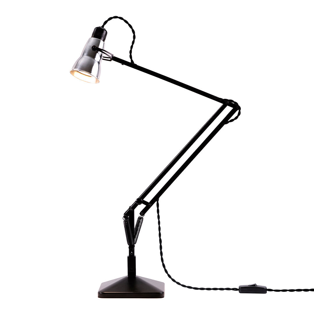 Black and silver adjustable desk lamp with a sleek, modern design and a textured base. 