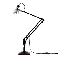 Black and silver adjustable desk lamp with a sleek, modern design and a textured base. 