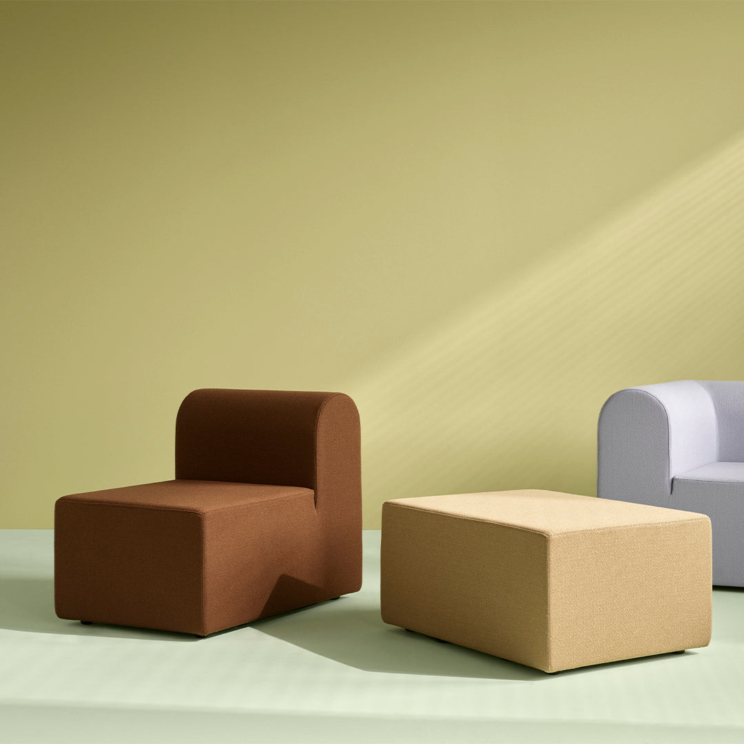 Modern furniture with brown, beige, and soft gray colors against a light green and yellow backdrop.