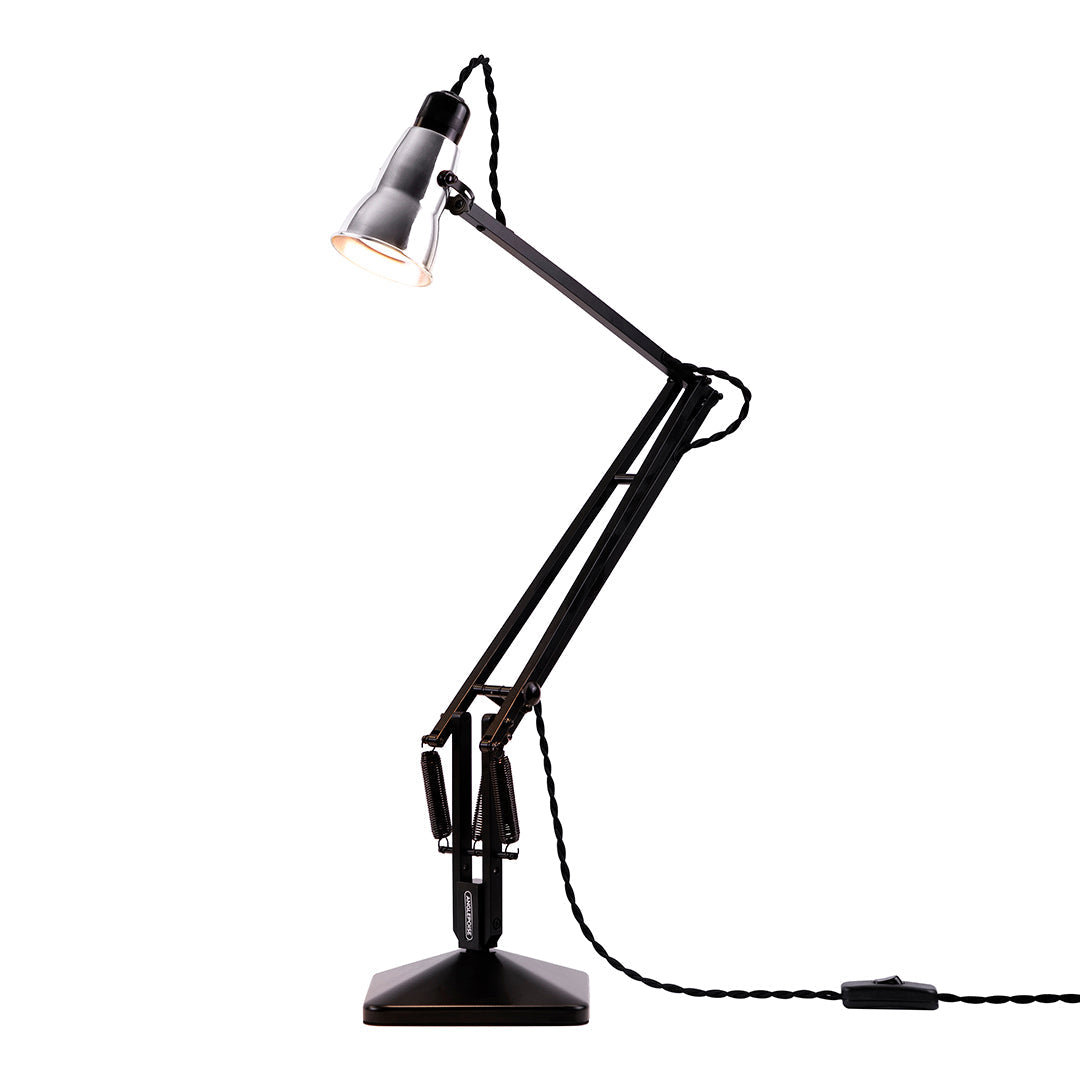 Black adjustable desk lamp with sleek finish and geometric design. Perfect for modern interiors.