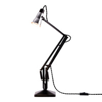 Black adjustable desk lamp with sleek finish and geometric design. Perfect for modern interiors.