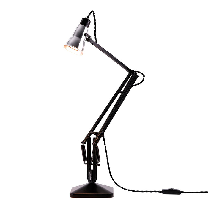Black adjustable desk lamp with sleek finish and geometric design. Perfect for modern interiors.