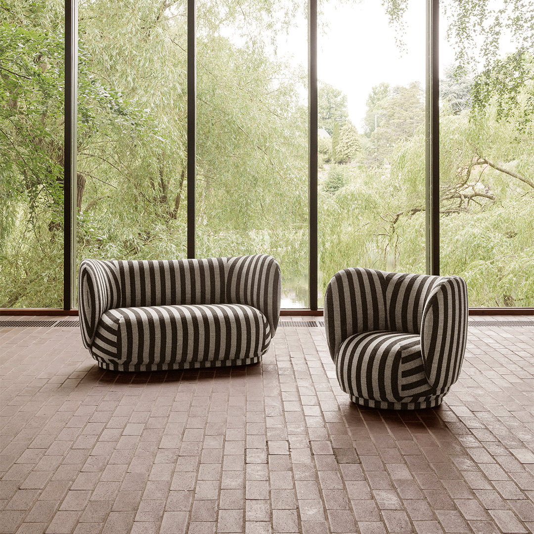 Black and white striped sofa and chair set, featuring bold patterns in a contemporary interior setting.