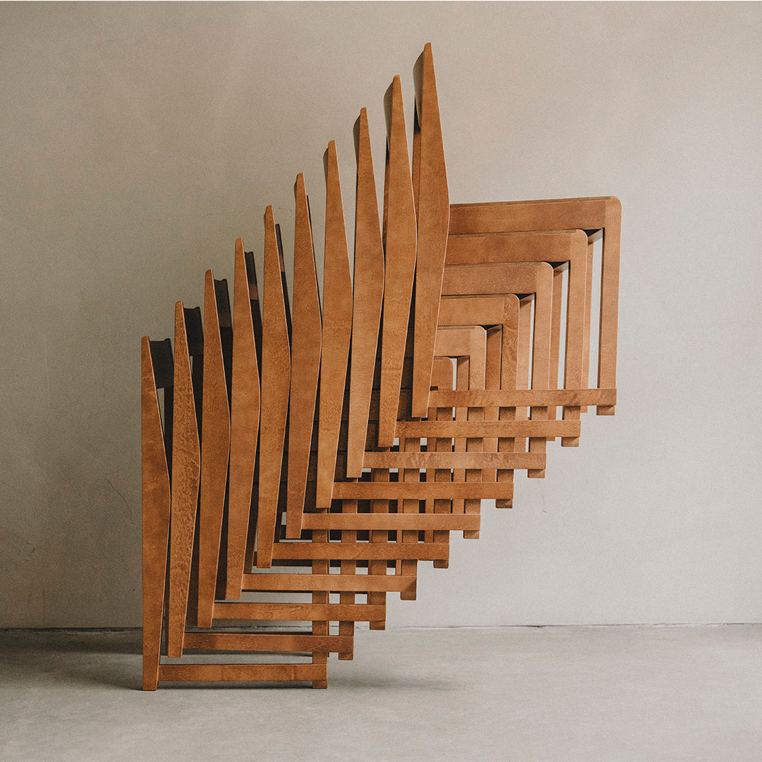 "Geometric wooden sculpture with a rich brown finish and angular patterns, creating a striking visual effect."