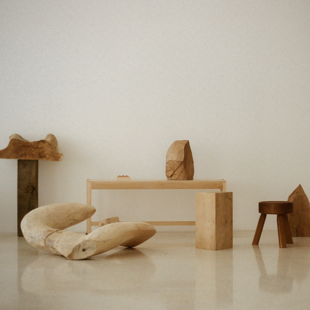 Natural wood tones with smooth and textured surfaces in a minimalist room setting. Earthy colors create a calming aesthetic.